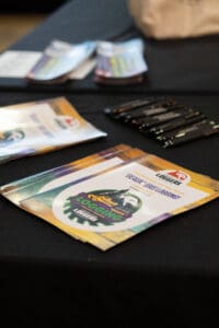 Brochures and pens on a black table.