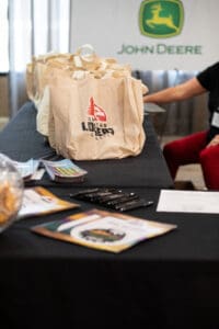 Promotional tote bags on display table.