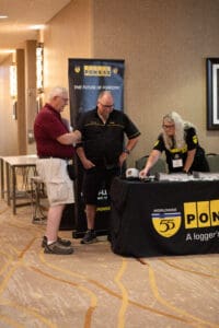 People at a forestry information booth event.
