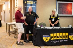 People at Ponsse exhibition booth discussing.