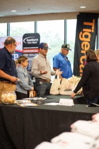 People at a promotional event booth.