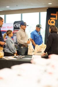 People at a trade show booth.