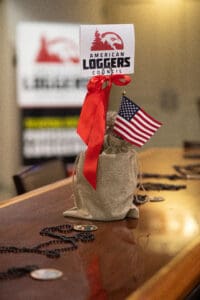 American Loggers Council sign with small flag.