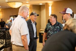 Men talking at a casual indoor event.