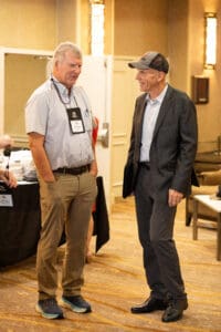 Two men conversing at a conference.