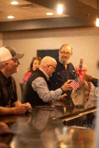People socializing at a bar counter.