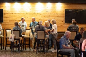 Group of people socializing in a restaurant.