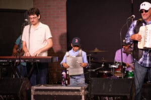Band performing with keyboard and washboard instruments.