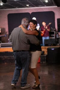 Couple dancing with live band playing.