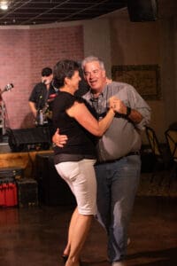 Couple dancing at a live music event.