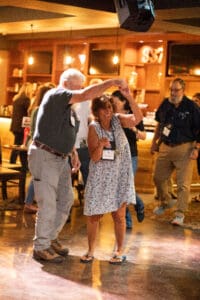 Older couple dancing at a social event.
