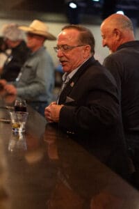 Man in suit at a bar counter.