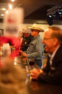 Elderly man wearing cowboy hat at bar
