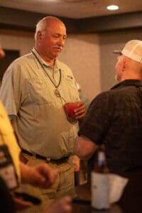 Two men talking at a social event.