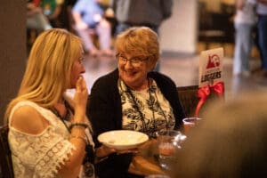 Two women talking at a restaurant table.