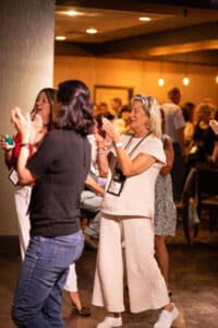 People clapping at a social event.