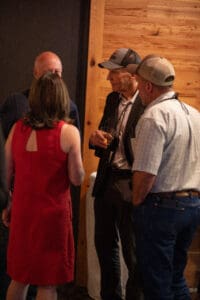 Group of people talking at an event.