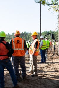 Construction workers gathered at a forest site.