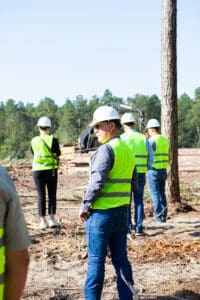 Construction crew in safety vests at logging site