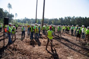 Workers in safety vests at construction site.
