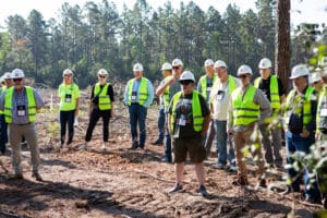 Group wearing safety vests at construction site.