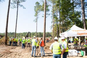 Workers gathered at construction site with equipment.