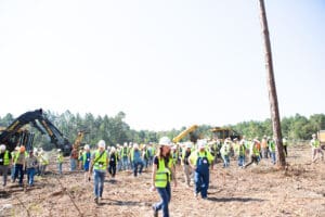 Construction workers in a forested area.