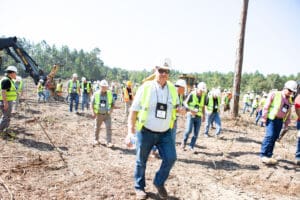 Group of workers in safety vests outdoors.
