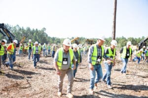 Construction workers wearing safety vests outdoors.