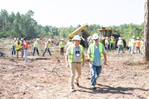 Construction workers in a forest clearing site.
