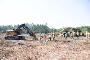 Construction site with workers and heavy machinery.