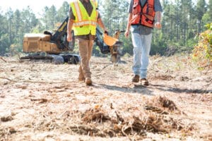 Workers in safety vests walking at construction site