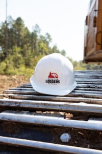 White hard hat on construction equipment outdoors.