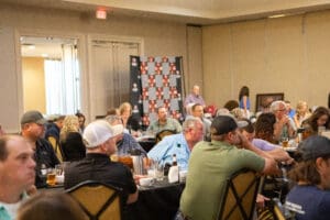 Attendees listening in conference banquet room