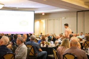Conference attendees seated at round banquet tables