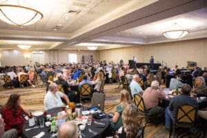 Large conference gathering in a banquet hall.