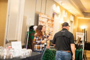People interacting at a conference booth.