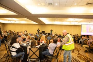 Crowded conference room with attendees and staff