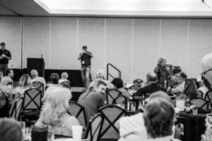 Conference attendees seated in a meeting room.