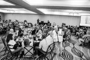 People seated at tables during event.