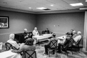 Group meeting in a small conference room.