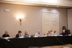 Panel discussion with six seated participants.