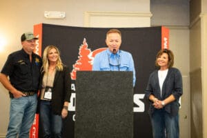 Four people speaking at a conference event.