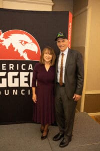 Two people posing at council event.