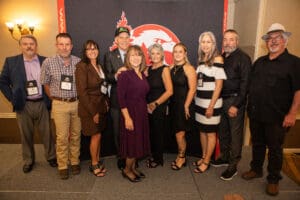 Group of people posing at event.