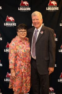 Man and woman posing at American Loggers event