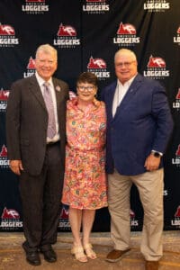 Three people posing at a council event.