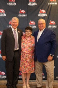 Three people posing at Loggers Council event.