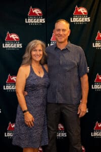 Smiling couple at American Loggers Council backdrop