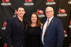Three people at American Loggers Council event.